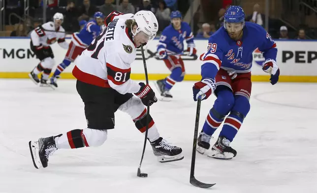 Ottawa Senators forward Adam Gaudette, left, takes a shot past New York Rangers defenseman K'Andre Miller during the second period of an NHL hockey game, Friday, Nov. 1, 2024, in New York. (AP Photo/John Munson)