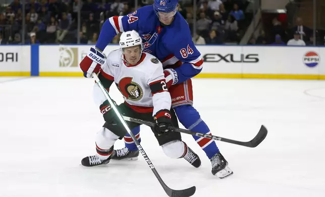 New York Rangers center Adam Edstrom (84) and Ottawa Senators center Nick Cousins (21) battle for the puck during the second period of an NHL hockey game, Friday, Nov. 1, 2024, in New York. (AP Photo/John Munson)