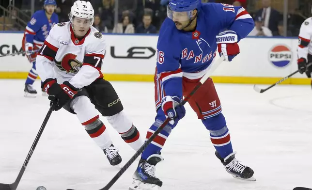 Ottawa Senators center Ridly Greig, left, and New York Rangers center Vincent Trocheck, right, battle for the puck during the first period of an NHL hockey game, Friday, Nov. 1, 2024, in New York. (AP Photo/John Munson)