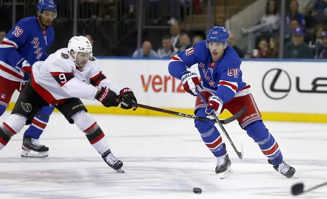 Ottawa Senators center Josh Norris, left, tries to slow down New York Rangers forward Will Cuylle, right, during the first period of an NHL hockey game, Friday, Nov. 1, 2024, in New York. (AP Photo/John Munson)