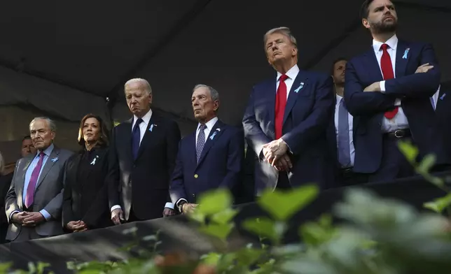 From left, Sen. Chuck Schumer, D-NY, Democratic presidential nominee Vice President Kamala Harris, President Joe Biden, Michael Bloomberg, Republican presidential nominee former President Donald Trump and Republican vice presidential nominee Sen. JD Vance, R-Ohio, attend the 9/11 Memorial ceremony on the 23rd anniversary of the Sept. 11, 2001 attacks, Wednesday, Sept. 11, 2024, in New York. (AP Photo/Yuki Iwamura)