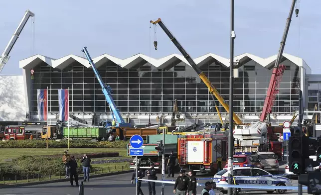 People and rescuers gather at the scene of an outdoor roof collapsed at a train station in Novi Sad, Serbia, Friday, Nov. 1, 2024. (AP Photo)
