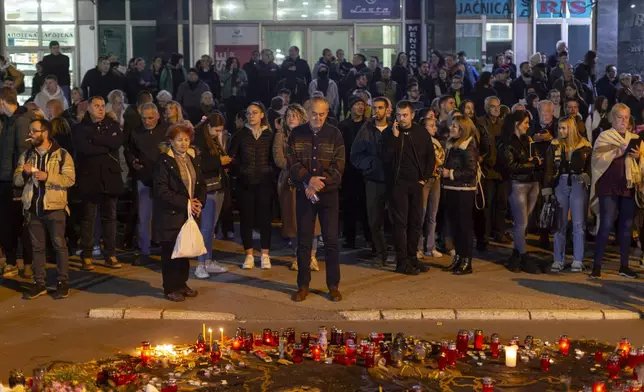 People pay respect to the 14 people killed at a local rail station during a protest in Novi Sad, Serbia, Tuesday, Nov. 5, 2024. (AP Photo/Marko Drobnjakovic)