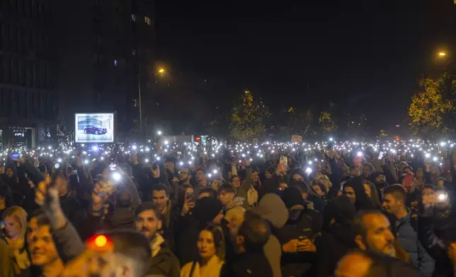 People light their mobile phones during a protest in Novi Sad, Serbia, Tuesday, Nov. 5, 2024. (AP Photo/Marko Drobnjakovic)