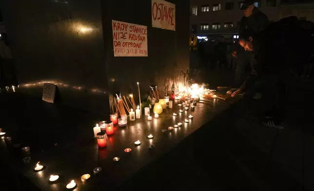 People light candles for the victims after an outdoor roof collapsed at a train station in Novi Sad, Serbia, Friday, Nov. 1, 2024. (AP Photo/Darko Vojinovic)