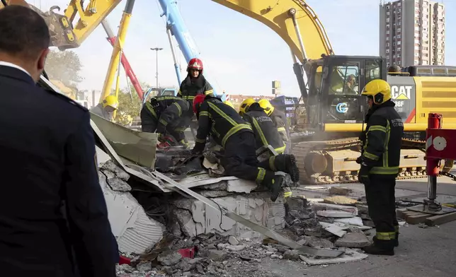 Rescue service workers inspect a scene as a roof collapsed at a railway station, Friday Nov. 1, 2024, in Novi Sad, Serbia. (Interior Ministry of Serbia via AP)