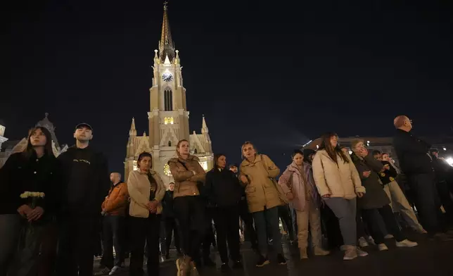 People light candles for the victims after an outdoor roof collapsed at a train station in Novi Sad, Serbia, Friday, Nov. 1, 2024. (AP Photo/Darko Vojinovic)