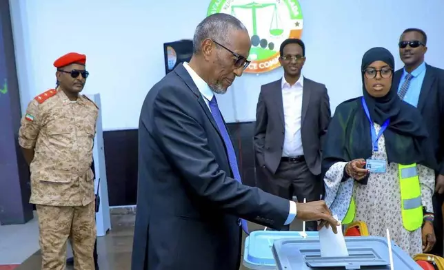 Somaliland President Muse Bihi Abdi, center, casts his vote inside a polling station during the presidential election in Hargeisa, Somaliland, Wednesday, Nov. 13,2024. (AP Photo/Abdirahman Aleeli)