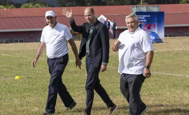 Britain's Prince William waves at well wishers during his visit at the Ocean View Secondary School in Cape Town, South Africa, Monday, Nov. 4, 2024. (AP Photo/Jerome Delay-pool)