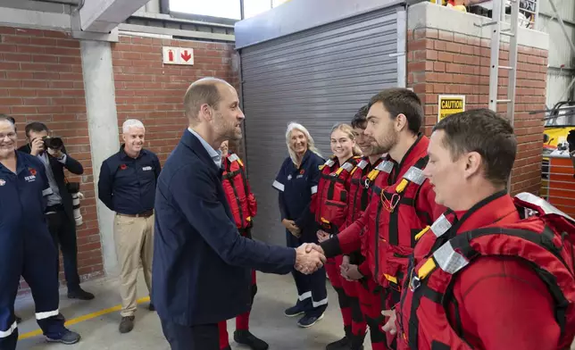 Britain's Prince William meets volunteers of the National Sea Rescue Initiative at Simon's Town harbour in Cape Town, South Africa, Thursday, Nov. 7, 2024. (AP Photo/Jerome Delay, Pool)