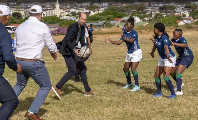 Britain's Prince William plays rugby with pupils at the Ocean View Secondary School in Cape Town, South Africa, Monday, Nov. 4, 2024. (AP Photo/Jerome Delay-pool)