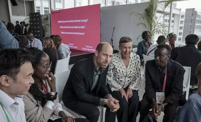 Britain's Prince William, center, and Hannah Jones, center right, CEO of The Earthshot Prize, speak to a group of young people at the Earthshot Prize Climate Leaders Youth Programme at Rooftop on Bree in Cape Town, South Africa, Monday Nov. 4, 2024. (Gianluigi Guercia/Pool Photo via AP)