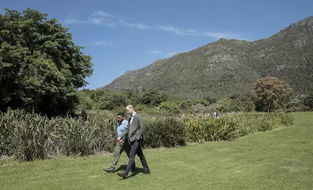 Britain's Prince William, Prince of Wales, right, walks with Garden Director Werner Voigt before a meeting with the 2024 Earthshot Prize Finalists, at Kirstenbosch National Botanical Garden in Cape Town, South Africa, Wednesday, Nov. 6, 2024. (Gianluigi Guercia, Pool Photo via AP)