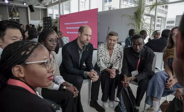 Britain's Prince William, center, and Hannah Jones, center right, CEO of The Earthshot Prize, speak to a group of young people at the Earthshot Prize Climate Leaders Youth Programme at Rooftop on Bree in Cape Town, South Africa, Monday Nov. 4, 2024. (Gianluigi Guercia/Pool Photo via AP)