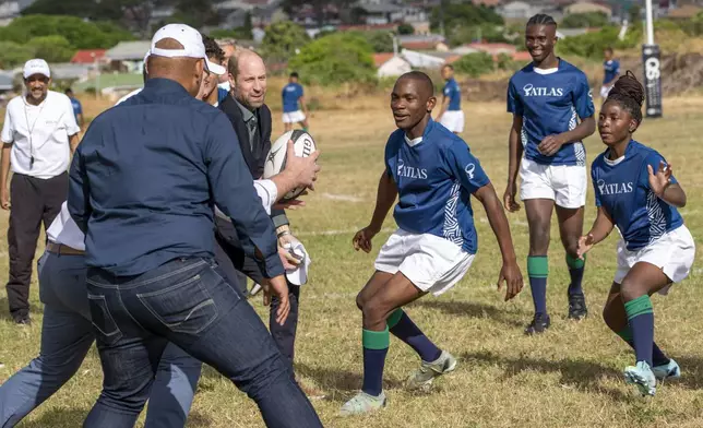 Britain's Prince William plays rugby with pupils at the Ocean View Secondary School in Cape Town, South Africa, Monday, Nov. 4, 2024. (AP Photo/Jerome Delay-pool)