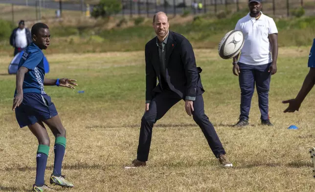 Britain's Prince William plays rugby with pupils at the Ocean View Secondary School in Cape Town, South Africa, Monday, Nov. 4, 2024. (AP Photo/Jerome Delay-pool)