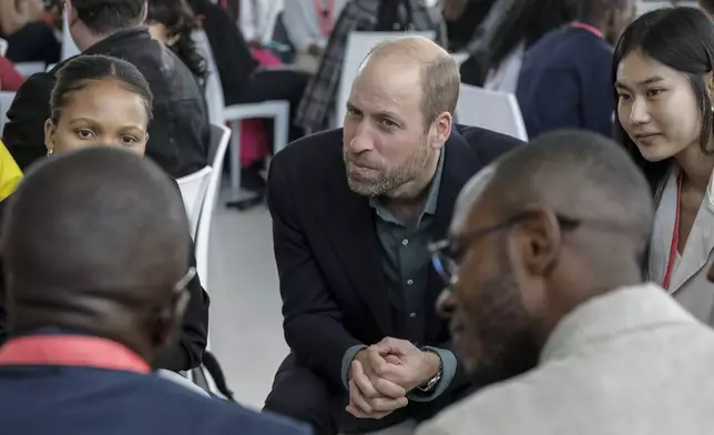 Britain's Prince William listens to a group of young people at the Earthshot Prize Climate Leaders Youth Programme at Rooftop on Bree in Cape Town, South Africa, Monday Nov. 4, 2024. (Gianluigi Guercia/Pool Photo via AP)