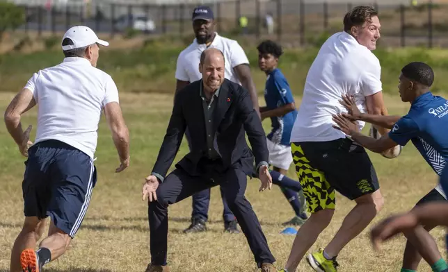 Britain's Prince William plays rugby with pupils at the Ocean View Secondary School in Cape Town, South Africa, Monday, Nov. 4, 2024. (AP Photo/Jerome Delay-pool)