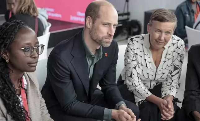 Britain's Prince William, center, and Hannah Jones, right, CEO of The Earthshot Prize, speak to a group of young people at the Earthshot Prize Climate Leaders Youth Programme at Rooftop on Bree in Cape Town, South Africa, Monday Nov. 4, 2024. (Gianluigi Guercia/Pool Photo via AP)