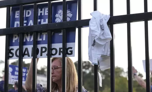 A protestor looks on prior to the scheduled execution of Richard Moore outside of Broad River Correctional Institution, Friday, Nov. 1, 2024, in Columbia , S.C. (AP Photo/Matt Kelley)