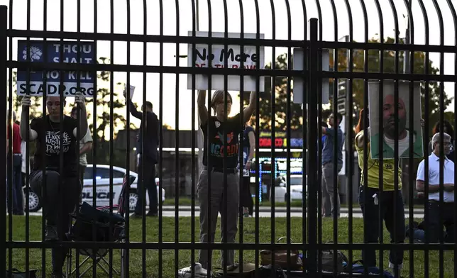 Protestors look on prior to the scheduled execution of Richard Moore outside of Broad River Correctional Institution, Friday, Nov. 1, 2024, in Columbia , S.C. (AP Photo/Matt Kelley)