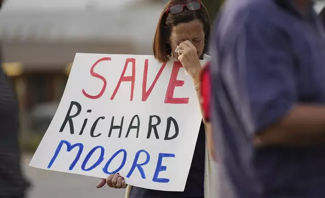 A protestor weeps prior to the scheduled execution of Richard Moore outside of Broad River Correctional Institution, Friday, Nov. 1, 2024, in Columbia , S.C. (AP Photo/Matt Kelley)