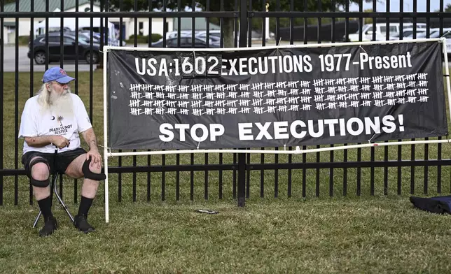 A protestor looks on prior to the scheduled execution of Richard Moore, Friday, Nov. 1, 2024, outside of Broad River Correctional Institution in Columbia , S.C. (AP Photo/Matt Kelley)