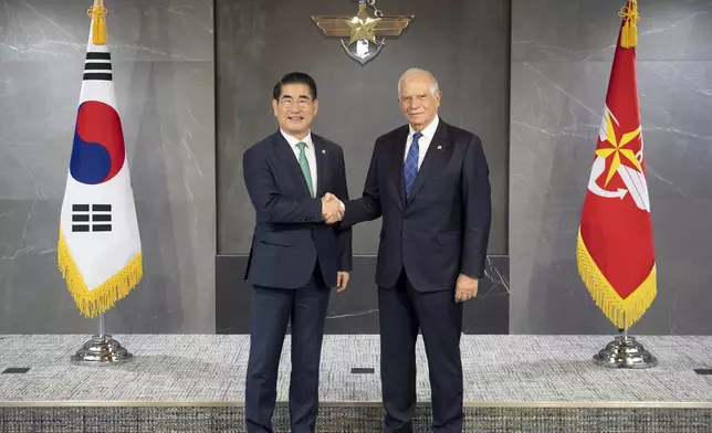 In this photo provided by South Korea Defense Ministry, South Korean Defense Minister Kim Yong Hyun, left, and European Union foreign policy chief Josep Borrell, right, pose for a photo at the Defense Ministry, in Seoul, South Korea, Monday, Nov. 4, 2024. (South Korea Defense Ministry via AP)