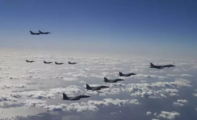 In this photo provided by the U.S. Air Force via South Korea Defense Ministry, U.S. Air Force B-1B bombers, F-16 fighter jets, South Korean Air Force F-15K fighter jets and Japanese Air Force F-2 fighter jets fly during a trilateral air drill at an undisclosed location, Sunday, Nov. 3, 2024. (U.S. Air Force/South Korea Defense Ministry via AP)