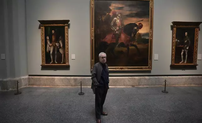 Novelist John Banville poses in front of Tiziano's 'The Emperor Charles V at Muhlberg' at the Prado Museum in Madrid, Spain, Wednesday, Oct. 23, 2024. (AP Photo/Paul White)