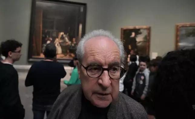 Novelist John Banville walks around looking at paintings including 'Diego Velazquez's 'Las Meninas' in the background at the Prado Museum in Madrid, Spain, Wednesday, Oct. 23, 2024. (AP Photo/Paul White)