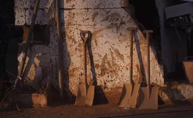 Shovels lean up against a wall during the clean up operation after flooding in Massanassa on the outskirts of Valencia, Spain, Wednesday, Nov. 6, 2024. (AP Photo/Alberto Saiz)