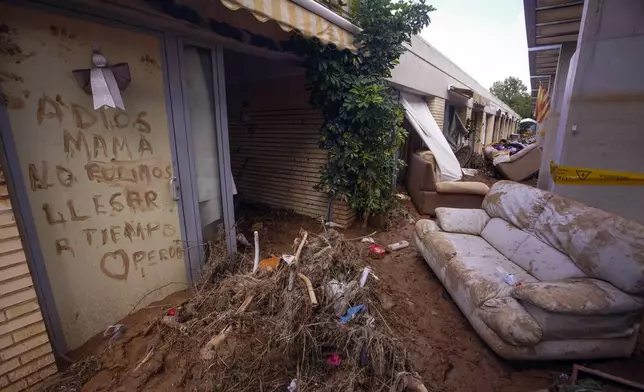 Writing on a wall of a centre for pensioners reads 'Goodbye mum. We didn't arrive on time. Sorry' after floods in Picanya on the outskirts of Valencia, Spain, Thursday, Nov. 7, 2024. (AP Photo/Alberto Saiz)