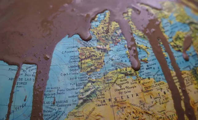 Part of a rotating World Globe Map showing Spain is covered in mud after floods in Paiporta, near Valencia, Spain, Monday, Nov. 4, 2024. (AP Photo/Alberto Saiz)