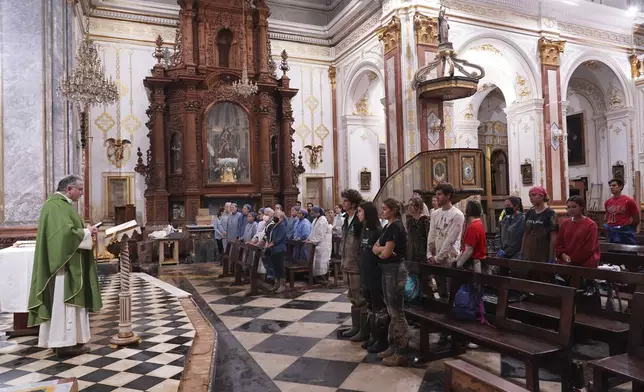 People attend a mass at the San Jorge church after floods in Paiporta, Spain, Thursday, Nov. 7, 2024. (AP Photo/Alberto Saiz)