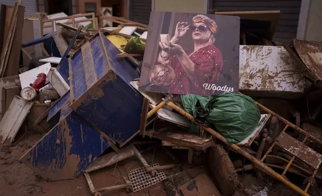 Items covered in mud are pictured in an area affected by floods, in Algemesi, Spain, Sunday, Nov. 3, 2024. (AP Photo/Manu Fernandez)