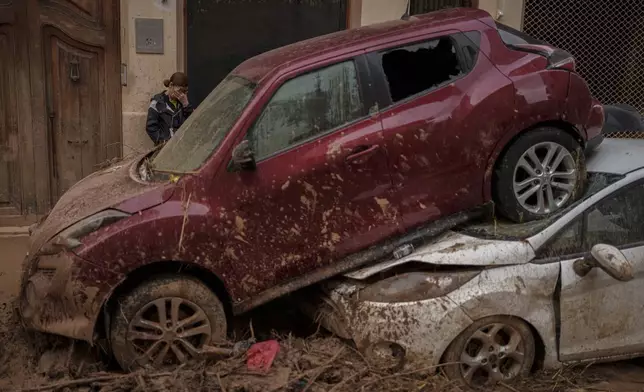 A woman reacts in an area affected by floods, in Algemesi, Spain, Sunday, Nov. 3, 2024. (AP Photo/Manu Fernandez)