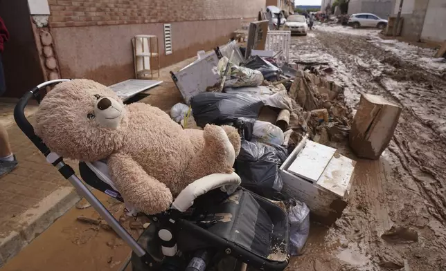 People's belongings sit in the mud after floods in Massanassa, just outside of Valencia, Spain, Saturday, Nov. 2, 2024. (AP Photo/Alberto Saiz)