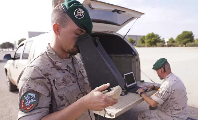 A soldier from the Spanish Parachute Squadron (EZAPAC) operates a drone in the search for bodies after floods in Barranco del Poyo on the outskirts of Valencia, Spain, Tuesday, Nov. 5, 2024. (AP Photo/Alberto Saiz)