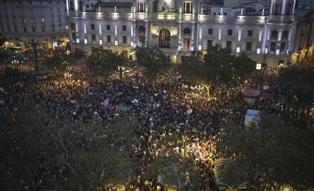 Thousands of demonstrators gather infant of the city council for a protest organized by social and civic groups, denouncing the handling of recent flooding under the slogan "MazÛn, Resign," aimed at the president of the regional government Carlos Mazon, in Valencia, Spain, Saturday, Nov. 9, 2024. (AP Photo/Emilio Morenatti)