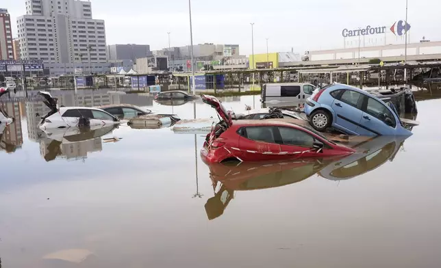 Cars are seen half submerged after floods in Valencia, Spain, Friday, Nov. 1, 2024. (AP Photo/Alberto Saiz)