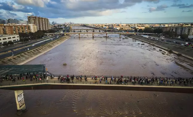 Volunteers return from helping affected municipalities four days after flash floods swept away everything in their path in the town of Paiporta, the epicentre of the storm, outskirts of Valencia, Spain, Saturday, Nov. 2, 2024.(AP Photo/Angel Garcia)