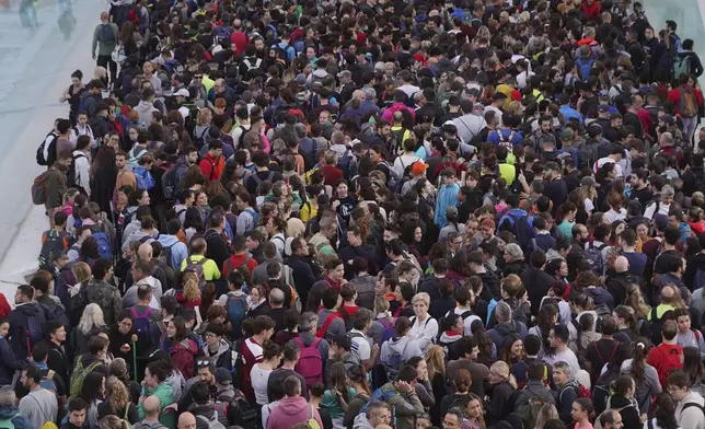 Thousands of volunteers show up at the City of Arts and Sciences cultural complex to be assigned work schedules to help with the clean up operation after floods in Valencia, Spain, Saturday, Nov. 2, 2024. (AP Photo/Alberto Saiz)