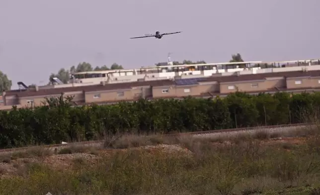 A drone operated by the Spanish Parachute Squadron (EZAPAC) flies over the area in the search for bodies after floods in Barranco del Poyo on the outskirts of Valencia, Spain, Tuesday, Nov. 5, 2024. (AP Photo/Alberto Saiz)