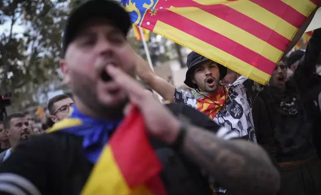 Demonstrators shout as they gather for a protest organized by social and civic groups, denouncing the handling of recent flooding under the slogan "Mazón, Resign," aimed at the president of the regional government Carlos Mazon, in Valencia, Spain, Saturday, Nov. 9, 2024. (AP Photo/Emilio Morenatti)