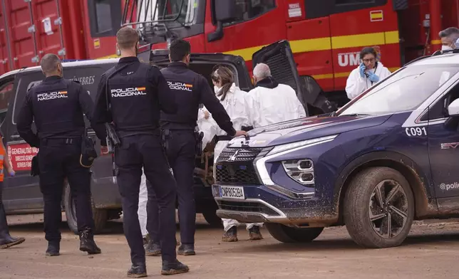 A body found in the MN4 shopping centre on the outskirts of Valencia, Spain is placed in a funeral van after floods in the Valencia area, Monday, Nov. 4, 2024. (AP Photo/Alberto Saiz)