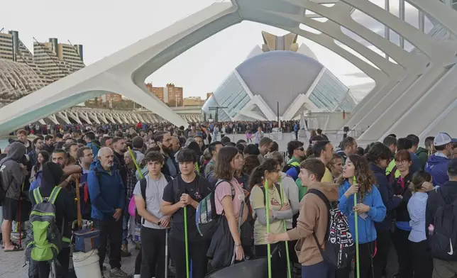 Thousands of volunteers show up at the City of Arts and Sciences cultural complex to be assigned work schedules to help with the clean up operation after floods in Valencia, Spain, Saturday, Nov. 2, 2024. (AP Photo/Alberto Saiz)