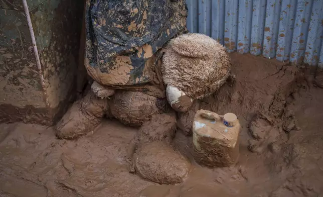 A teddy bear covered in mud is pictures in an area affected by floods in Paiporta, a town in the region of Valencia, Spain, Saturday, Nov. 2, 2024. (AP Photo/Manu Fernandez)