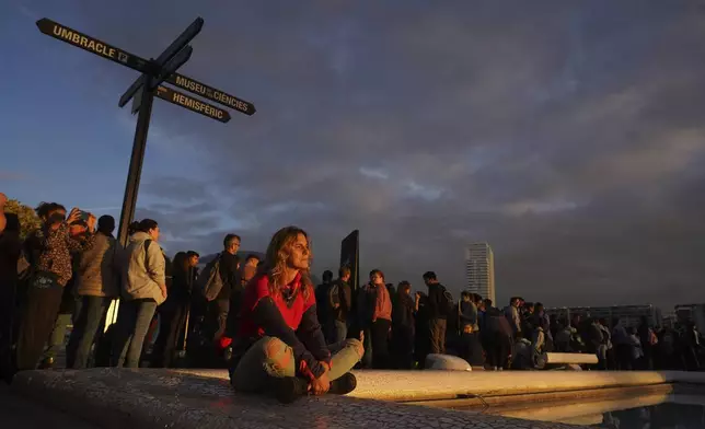 Volunteers wait after thousands showed up to be assigned work schedules to help with the clean up operation after floods in Valencia, Spain, Saturday, Nov. 2, 2024. (AP Photo/Alberto Saiz)