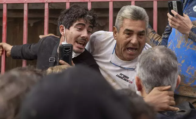 Angry Spanish flood survivors confront King Felipe VI in the devastated town of Paiporta, near the city of Valencia, on Nov. 3, 2024. (AP Photo/David Melero)